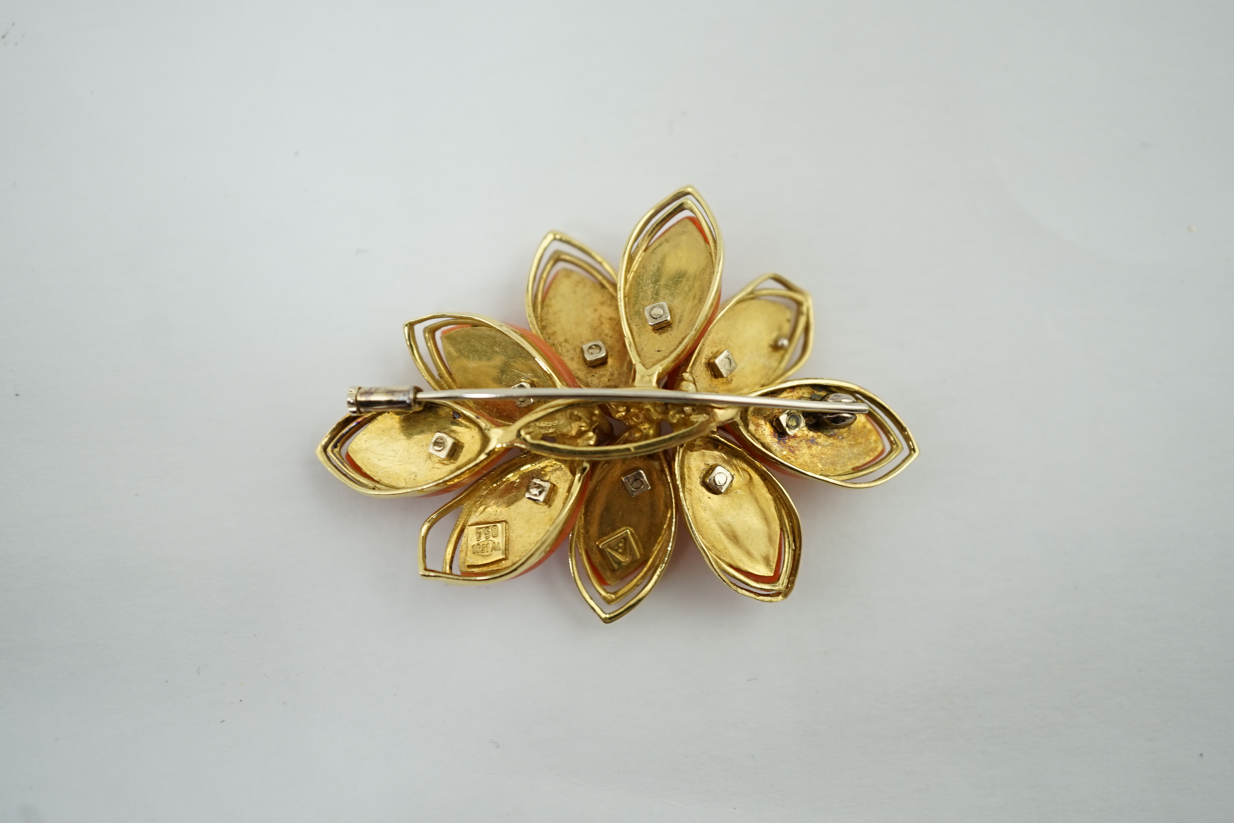 A modern Italian 18k gold, coral and diamond chip set leaf brooch